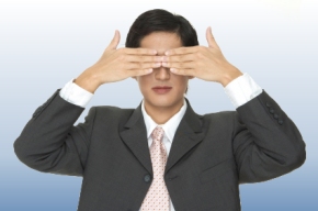 businessman with his hands over his eyes